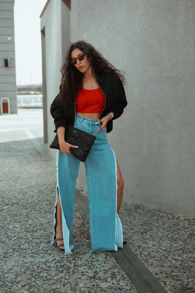 Stylish woman in chic outfit posing outdoors; perfect for fashion and lifestyle themes.